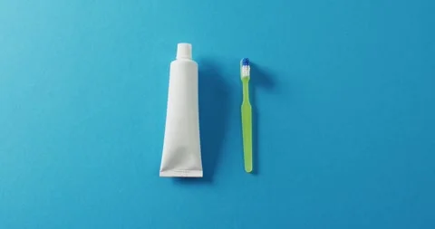 Video of close up of toothbrush and paste on blue background Stock Footage 331245872