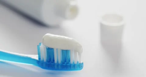 Video of close up of toothbrush and paste on white background Stock Footage 331294736