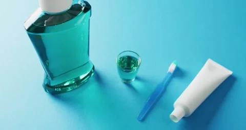 Video of close up of toothbrush, paste and mouthwash on blue background Stock Footage 331211017