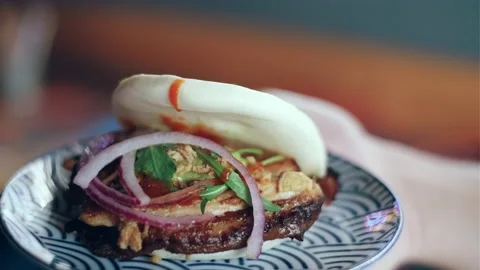 Video of close up of waitress hand serving bao in thre restaruant Stock Footage 219605797