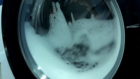 Video of clothes spinning at high speed inside an automatic washing machine.. 動画素材 340340905