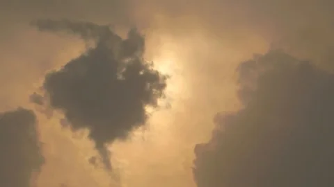 Video of clouds passing in front of the sun camera facing at sun Stock Footage