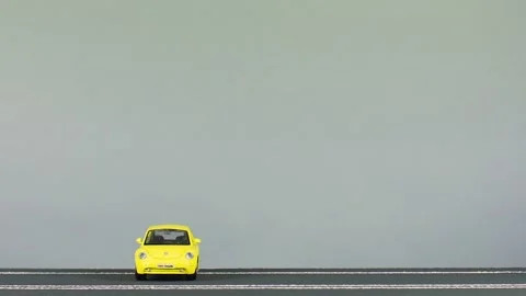 Video of a collision between two car figurines, an yellow and a red one. Stock Footage 133489925