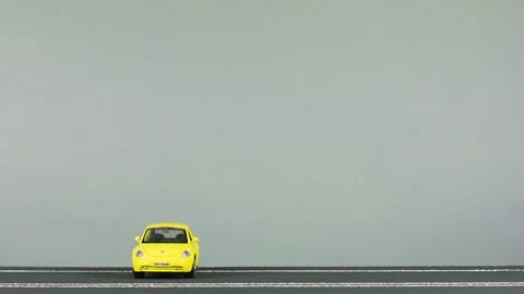 Video of a collision between two car figurines, an yellow and a rusty red one Stock Footage 133490027
