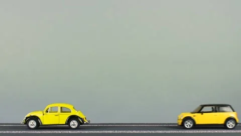 Video of a collision between two cool, yellow car figurines. Stock Footage 133489799