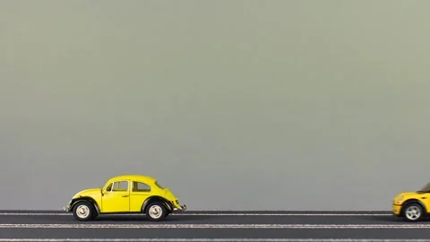 Video of a collision between two new, yellow car figurines. Stock Footage 133489748