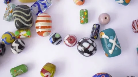 Video of colorful beads on a white background Stock Footage 147740153
