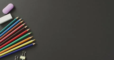 Video of composition with colorful crayons and school tools on grey surface with Stock Footage 331245664