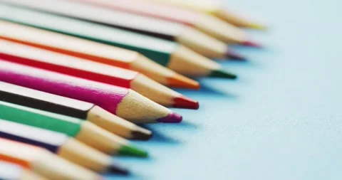 Video of composition with colorful crayons on light blue surface Stock Footage 331294433