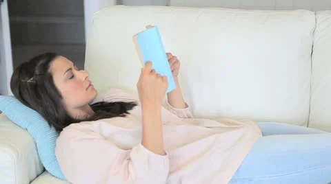 Video of concentrated woman reading a novel Stock Footage