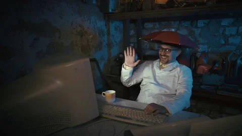 Video conference in virtual chat. Computer nerd with an umbrella on his head. Видео 139966105