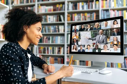 Video conferencing using app and computer. Mixed race female student, studying Stock Photos