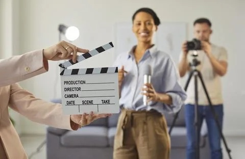 Video content recording, studio backstage scene with clapperboard, happy Stock Photos