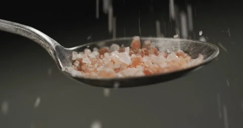 Video of cook throwing salt on the table on black background Stock Footage 344332873
