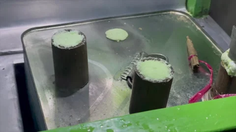 Video cooking or serving kue putu (traditional steamed rice cake) Stock Footage 321554442