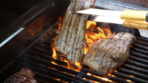 Video of cooking steaks on the fire in real slow motion Stock Footage 74877547