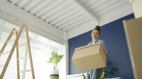 Video of couple going with cardboard boxes while moving house Stock Footage 131956916
