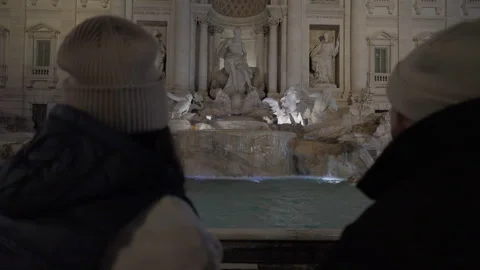 Video of a couple sitting down in front of the Trevi Fountain Stock Footage 266854210