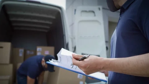 Video of couriers unloading packages and checking documents. Stock-Footage 155730582