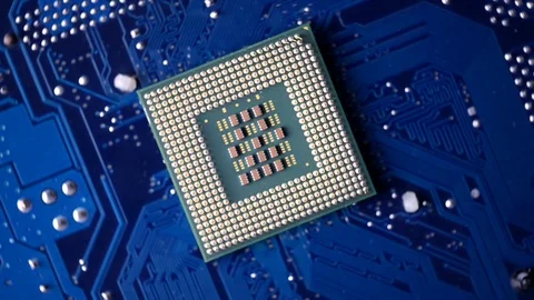 VIDEO, CPU against electric circuit board or motherboard rotating footage Stock Footage 100611428