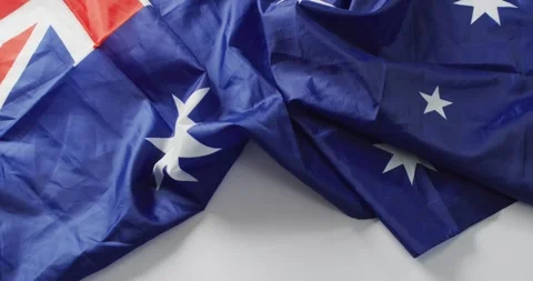 Video of creased flag of australia lying on white background Stock Footage 337699576