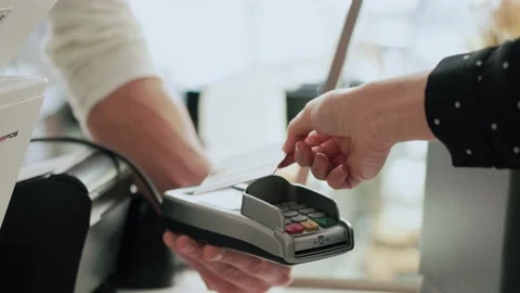 Video of customer using her credit card to make payment with electronic reade Stock Footage 193410822