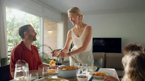 Video of cute family talking while eating together in the kitchen at home Stock Footage 251890797