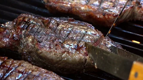 Video of cutting steak on the grill in real slow motion Stock Footage