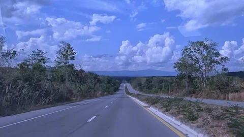 Video from the dashcam of a car driving on a long straight road. Stock Footage 259690809