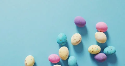 Video of decorated colorful easter eggs on a blue surface Stock Footage 343836223