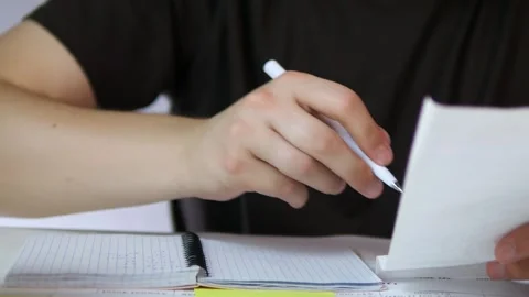 The video demonstrates the practical process of manual bookkeeping as hands Stock-Footage 319001192