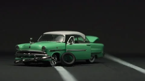 Video of a destroyed, abandoned, light blue, retro car figurine left in the m Stock Footage 133492141