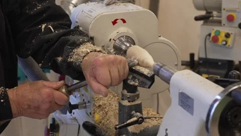 Video detail of hands of master turner turning a piece of wood on a lathe Stock Footage 242079620