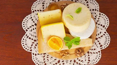 Video of different types of hard and soft cheeses on cutting board Stock Footage 305444131
