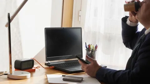 Video of a director taking a break from work and having a quick coffee at hom Stock Footage 151555456