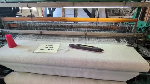 Video documenting a preserved textile loom with woven fabric and thread systems Stock Footage 336131130