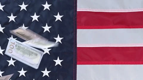 Video of dollar bills falling against american flag Stock Footage 316688856