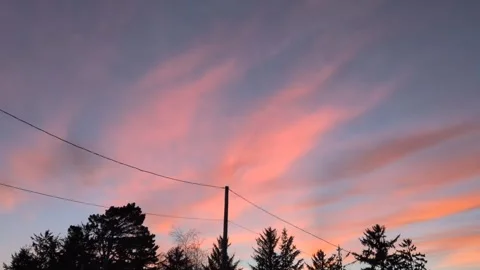 Video of dramatic blue sky streaked with pink and red clouds Stock Footage 329139591