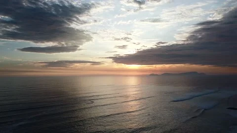 Video of a dramatic sunset over the ocean with storm clouds in the sky. Stock Footage 236274360