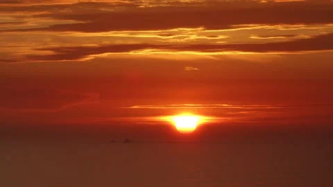 Video of a dramatic sunset over the ocean with storm clouds in the sky. Stock Footage 236274754