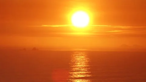 Video of a dramatic sunset over the ocean with storm clouds in the sky. Stock Footage 236274758