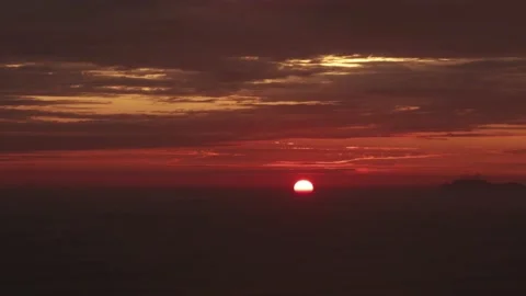 Video of a dramatic sunset over the ocean with storm clouds in the sky. Stock Footage 236274759