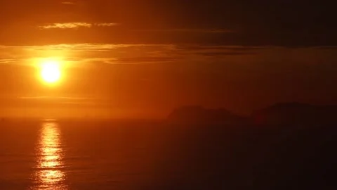 Video of a dramatic sunset over the ocean with storm clouds in the sky. Stock Footage 236274775