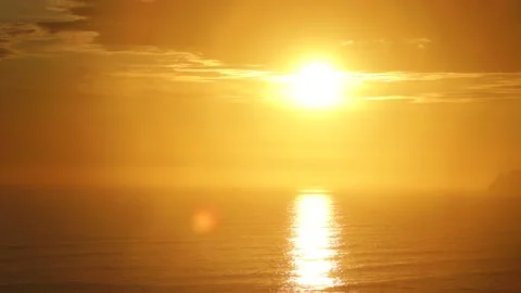Video of a dramatic sunset over the ocean with storm clouds in the sky. Stock Footage 236274785