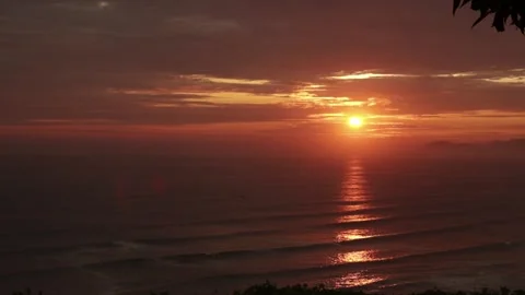 Video of a dramatic sunset over the ocean with storm clouds in the sky. Stock Footage 236274799