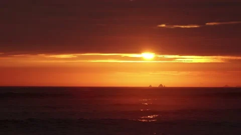 Video of a dramatic sunset over the ocean with storm clouds in the sky. Stock Footage 236274801