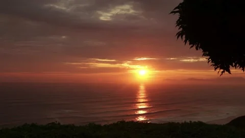 Video of a dramatic sunset over the ocean with storm clouds in the sky. Stock Footage 236274845