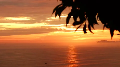 Video of a dramatic sunset over the ocean with storm clouds in the sky. Stock Footage 236274850