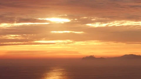 Video of a dramatic sunset over the ocean with storm clouds in the sky. Stock Footage 236274869