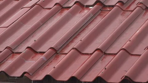Video of Drizzling Rain Water Dripping, Hitting the red Concrete Tiles Roof Stock Footage 336571364